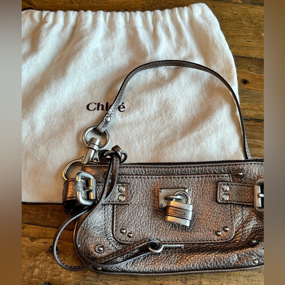 Chloe’ Paddington wristlet comes with lock, key and dust bag.